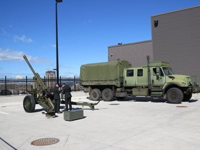 A howitzer and military transport truck