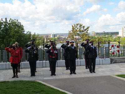 Honour guard saluting in front of the tablets