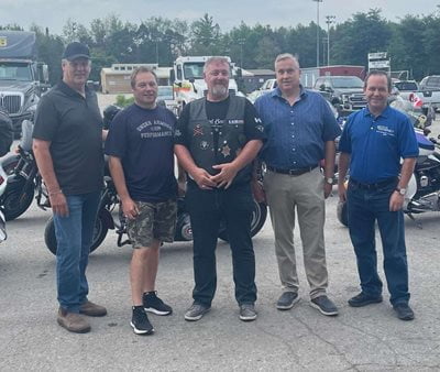 The rolling barrage outside for a photo in front of their motorcycles