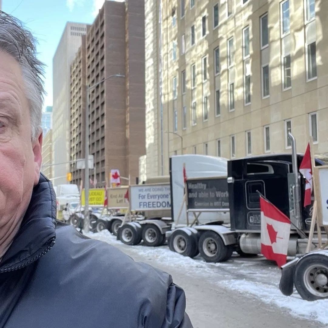 Rob Stinson with trucks behind him in Ottawa