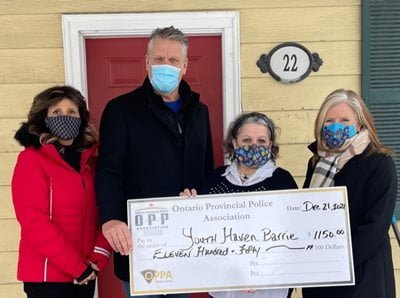 A cheque being donated to the youth haven