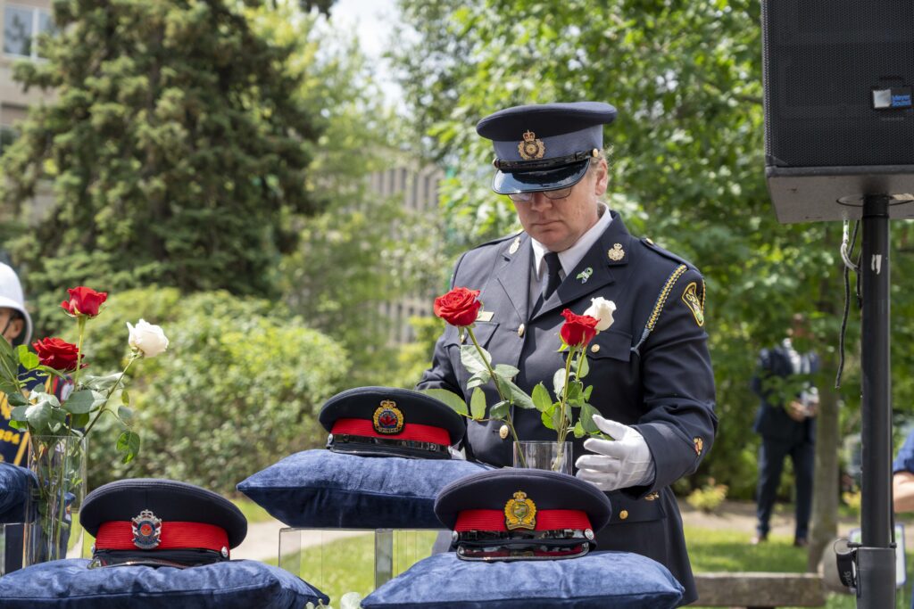 OPPA Director Lynn Neale lays a rose at Ontario Police Suicide Memorial 2024